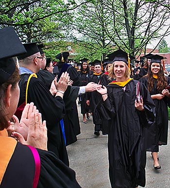 Faculty members applaud graduates after the 2013 undergrad ceremony.