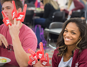 Students sport foam fingers during the lunchtime pep rally.