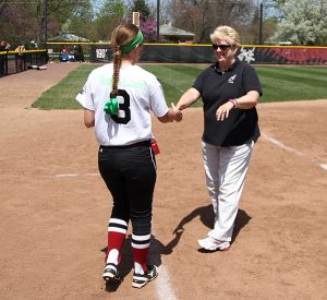 Sue Willey, right, greets an athlete