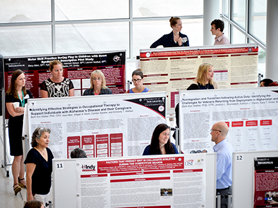 UIndy students show research posters in the atrium of the Health Pavilion as part of the first annual Health Pavilion Scholarship Day hosted by the Health Science Colleges on Friday, May 19, 2017. The event was followed by the Second Annual Multidisciplinary Scholarly Activity Symposium held by Community Health Network with UIndy partnership support. Chad Priest, RN, JD, Chief Executive Officer of he American Red Cross of Indiana Region, is the speaker delivering a keynote on "The Healthcare Professionals of the Future" in Schwitzer following the luncheon. (Photo: D. Todd Moore, University of Indianapolis)