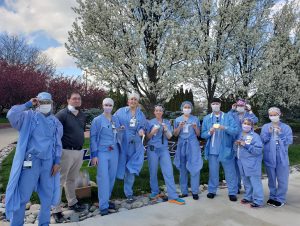 Healthcare workers at St. Vincent Hospital in Indianapolis model face shields manufactured by James Emery, lab manager at the R.B. Annis School of Engineering.