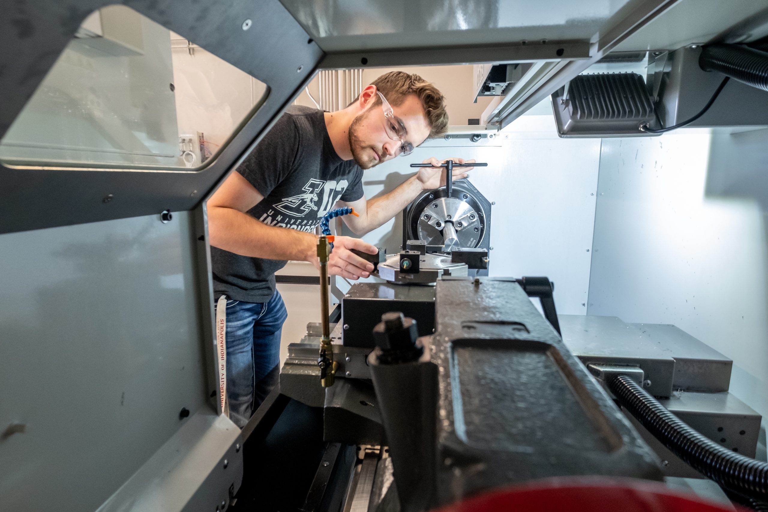 A student works in the engineering machine shop at the R.B. Annis School of Engineering