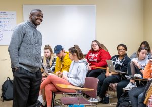 Terrence Harewood working with students in classroom