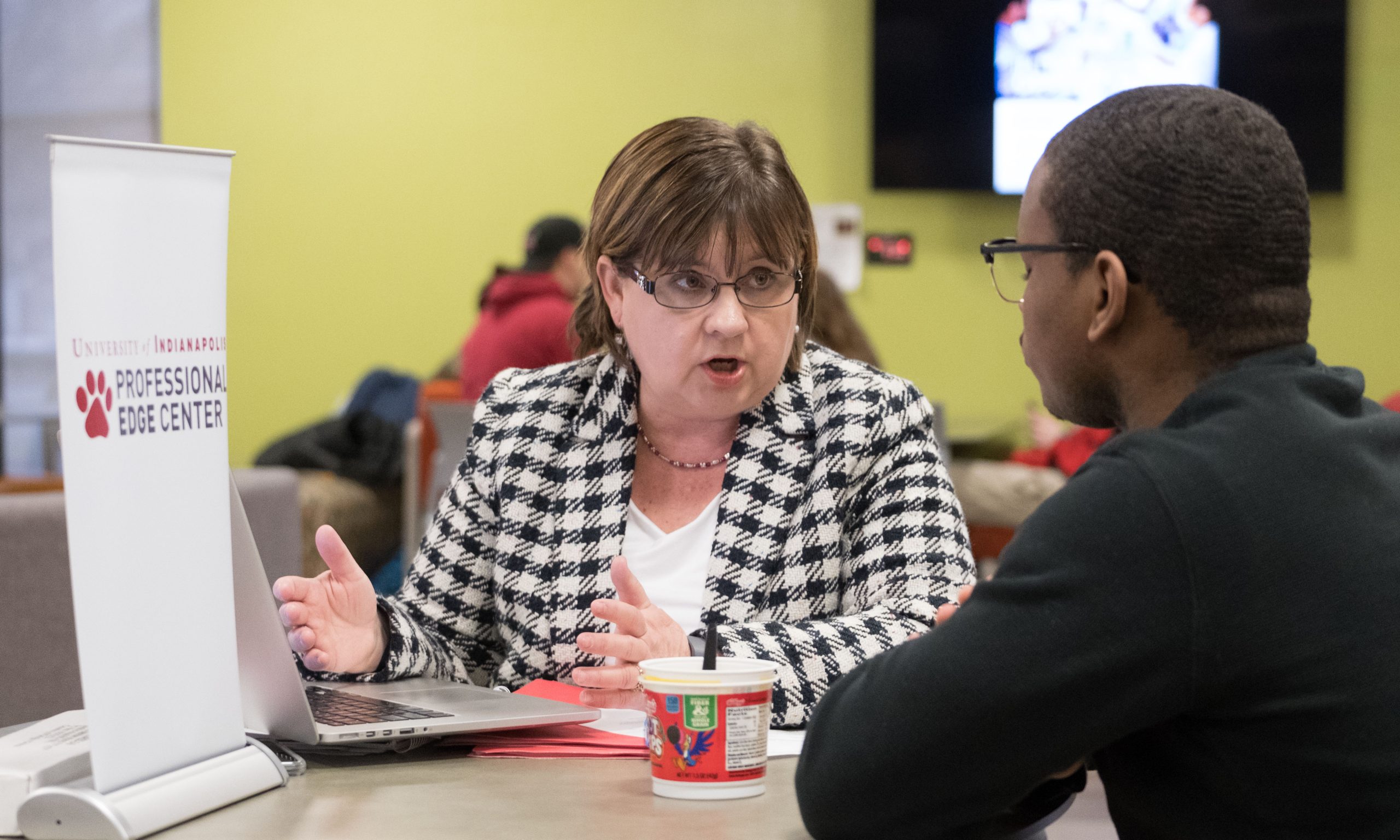 A student receives advice from a member of the Professional Edge Center staff