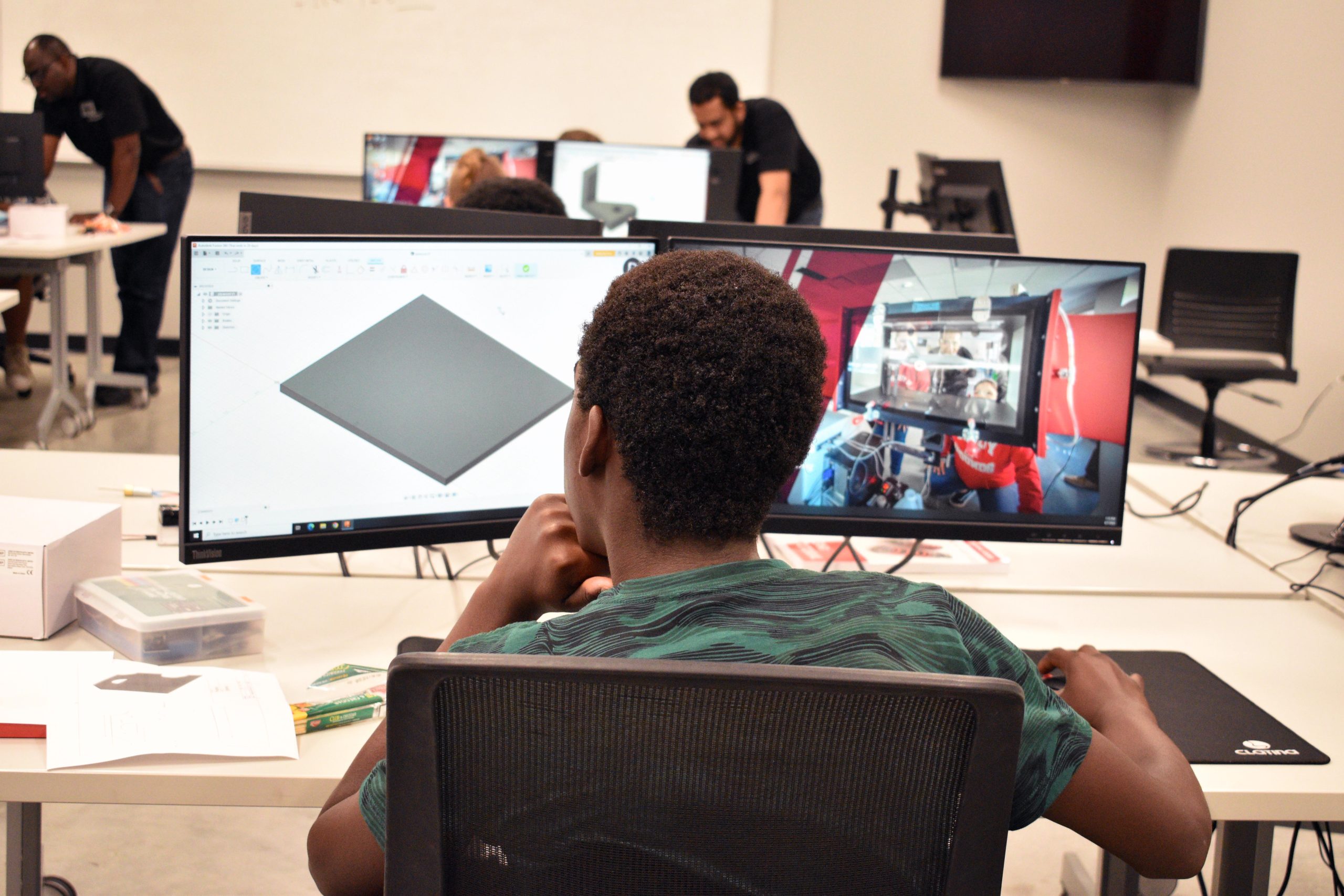 Engineering student sits at his desk