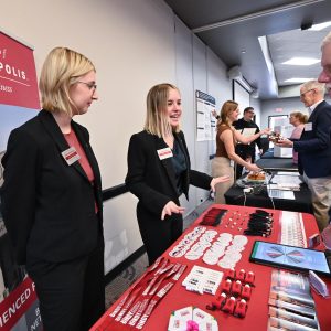 UIndy School of Business students man a table at Philanthropy Lunch