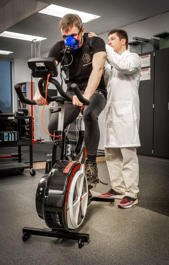 Student on stationary bike in the Human Performance Lab in HEAL 378