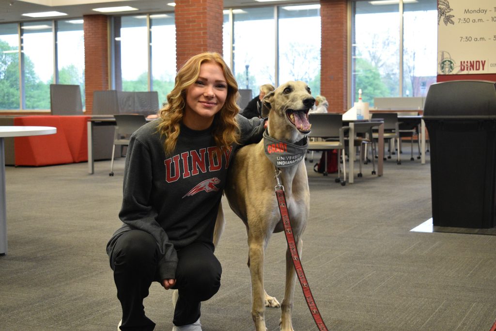 New UIndy student poses with Grady the Greyhound