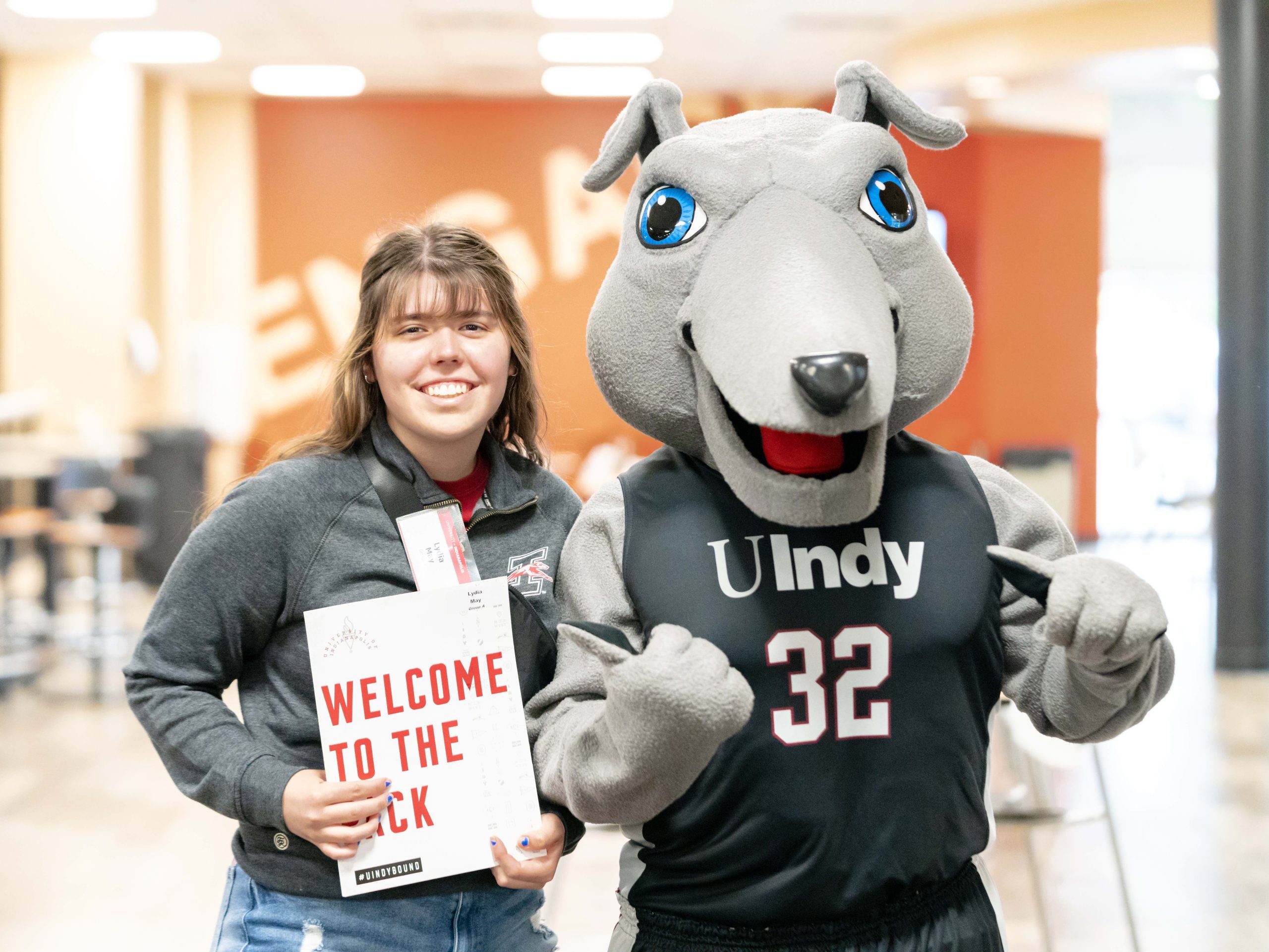 New UIndy student poses with Ace, UIndy's costumed mascot