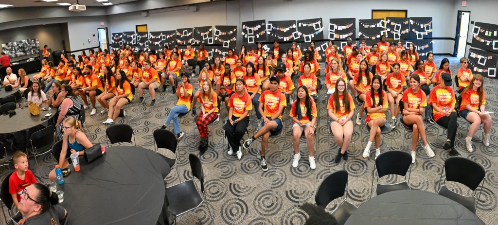 Students in the 2024 UIndy Summer Success Camp in UIndy Hall after completing a vision board activity