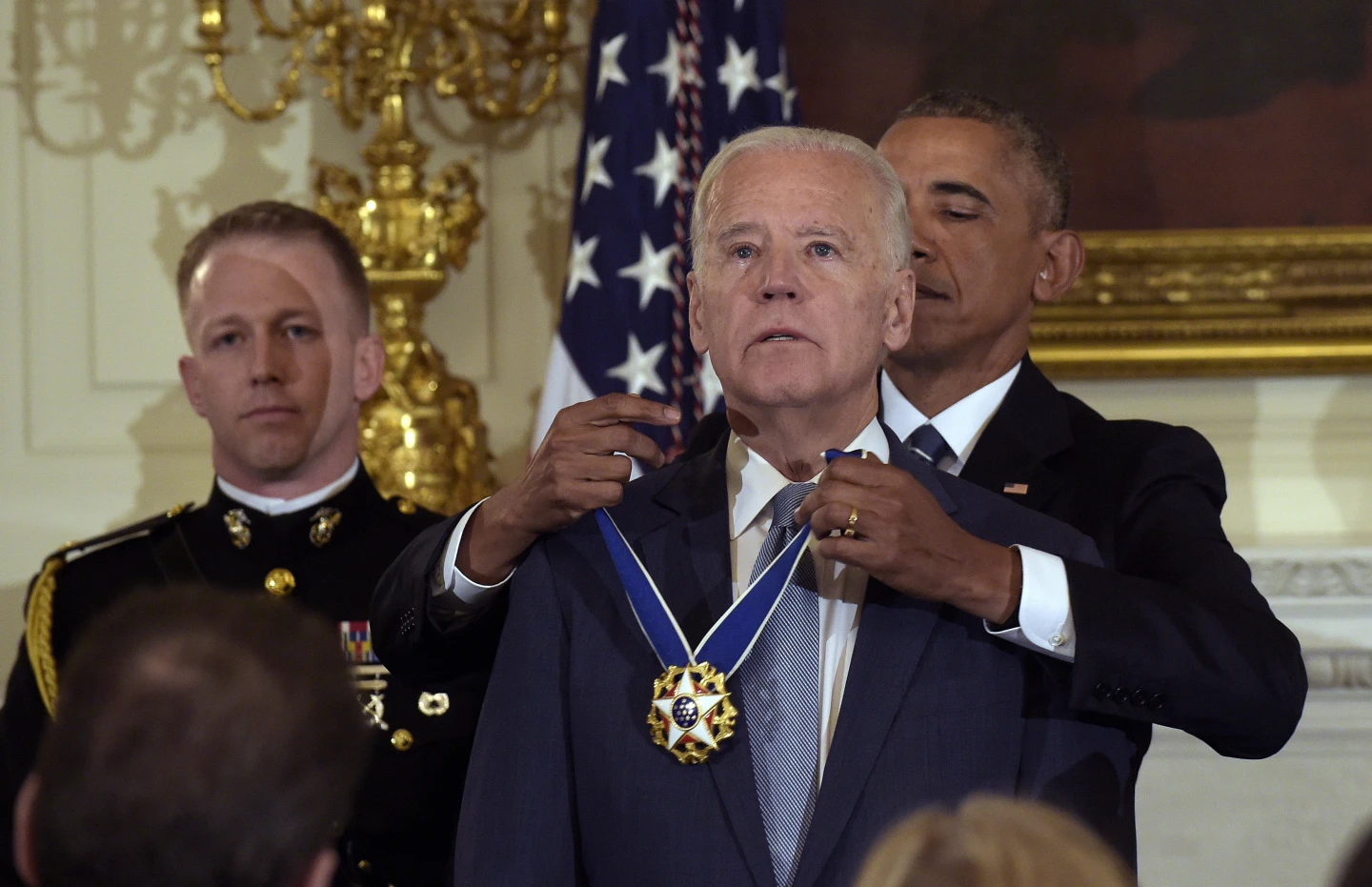 President Barack Obama presents Vice President Joe Biden with the Presidential Medal of Freedom during a ceremony in the State Dining Room of the White House in Washington, Jan. 12, 2017. (AP Photo/Susan Walsh)