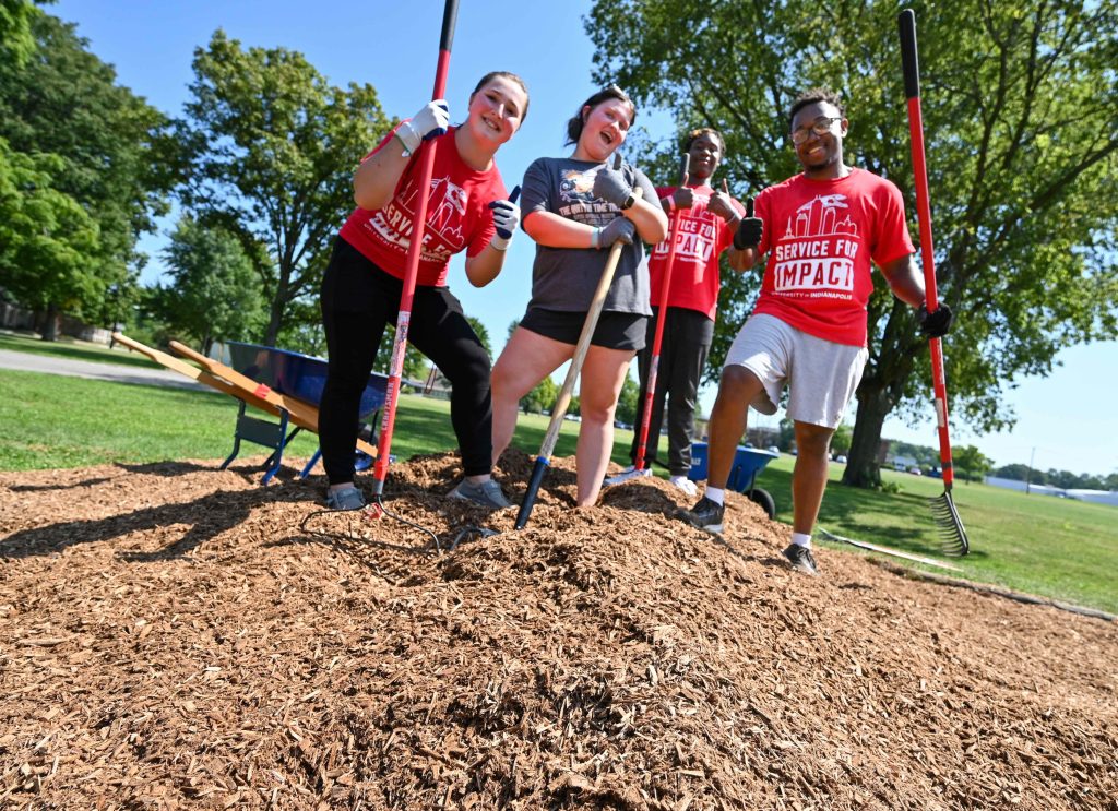 Group photo of students shoveling mulch at Indy Parks