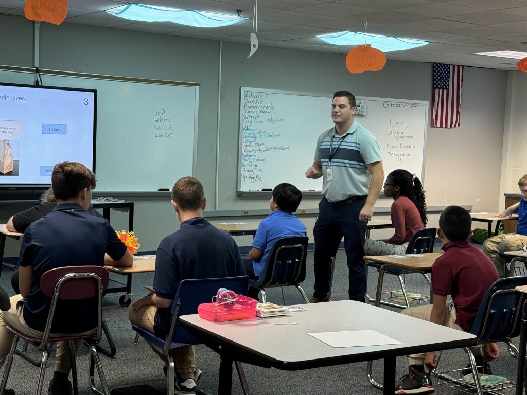 Special education teacher (and I-SEAL participant) Andrew Bova helps his class learn about adjectives by describing items from a bag at Perry Meridian Middle School.