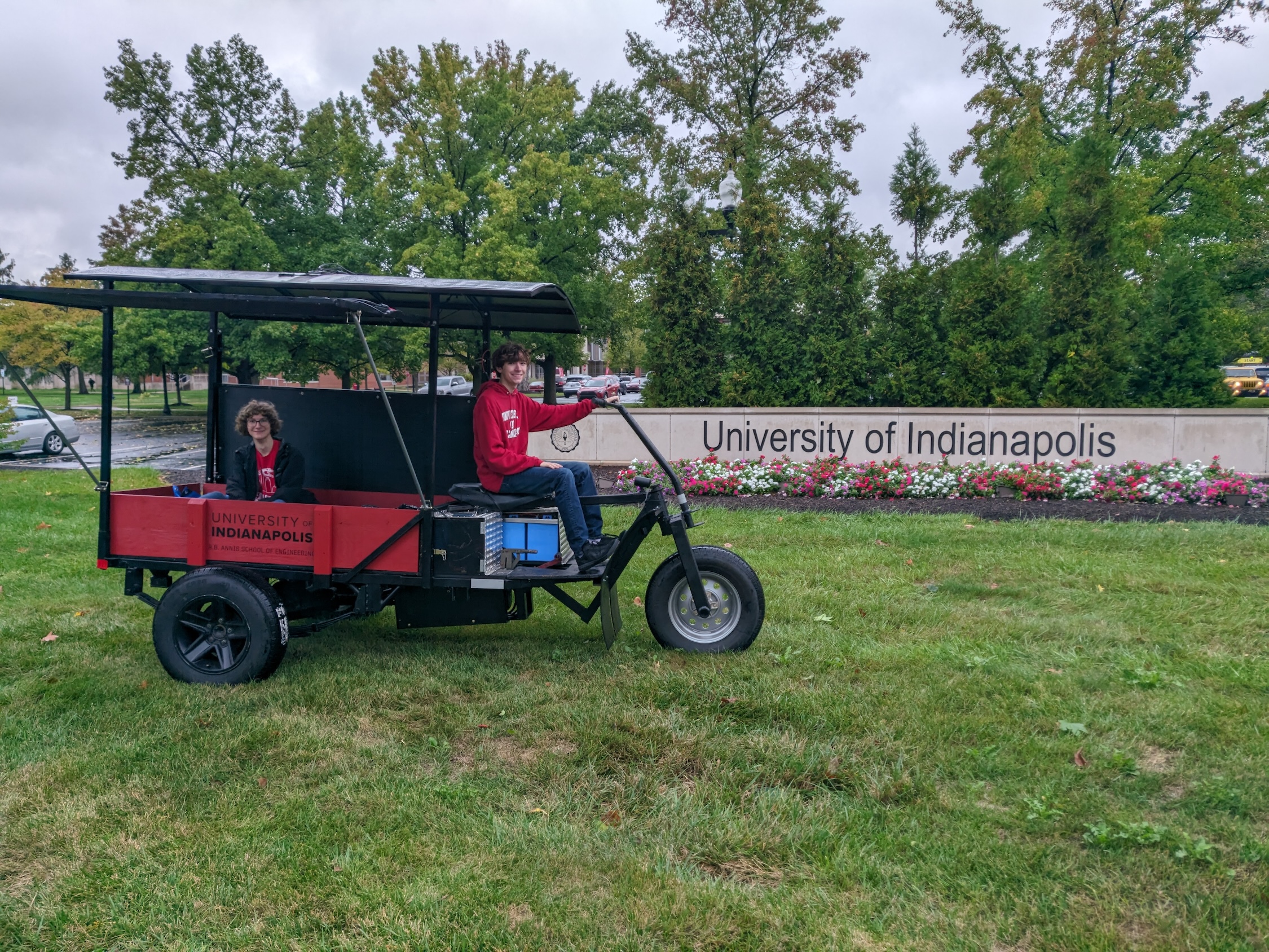 The eBUV is parked in front of the University of Indianapolis sign