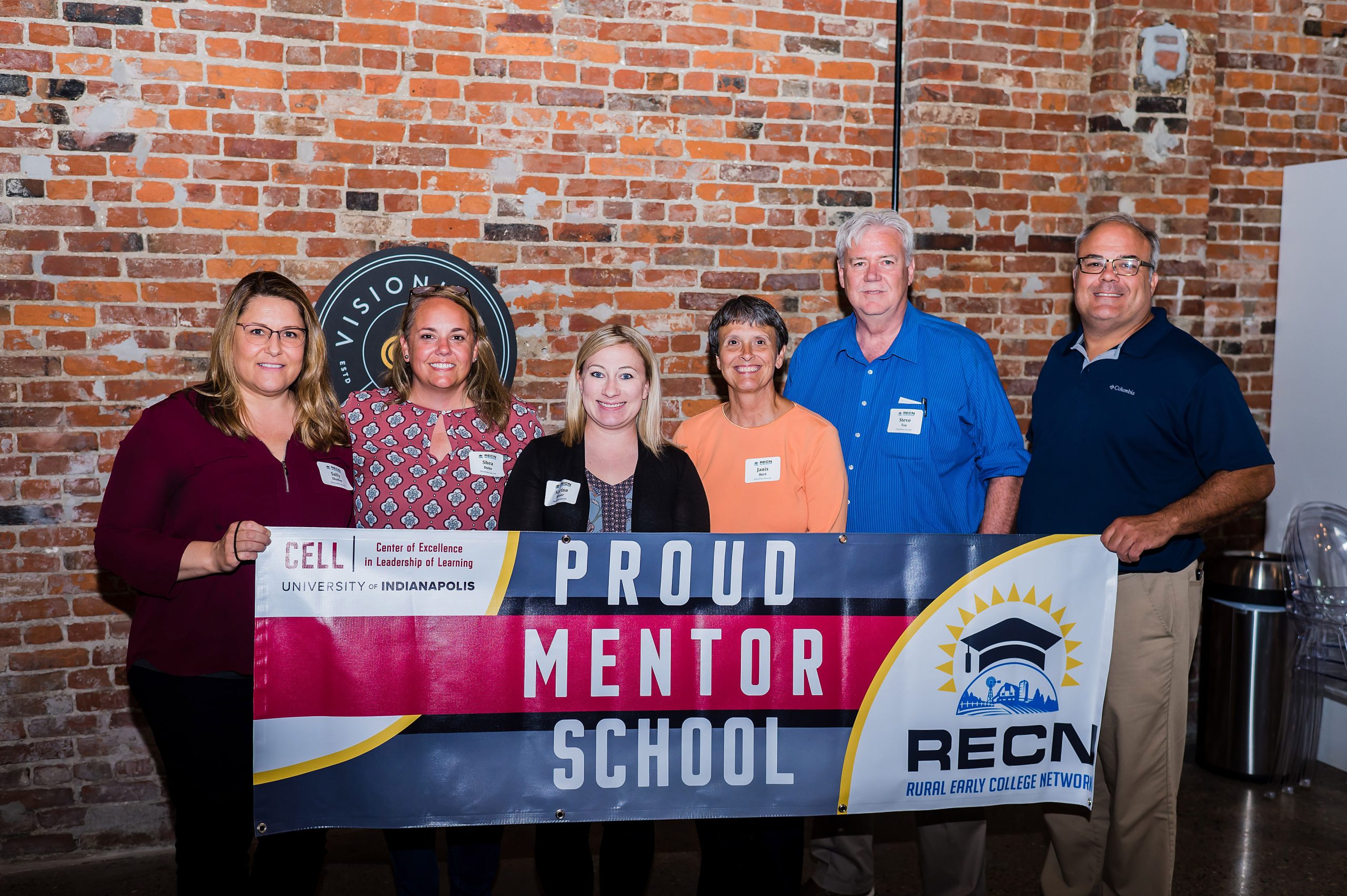 Educators from Lincoln High School in Vincennes hold a banner during a retreat as part of RECN 1.0