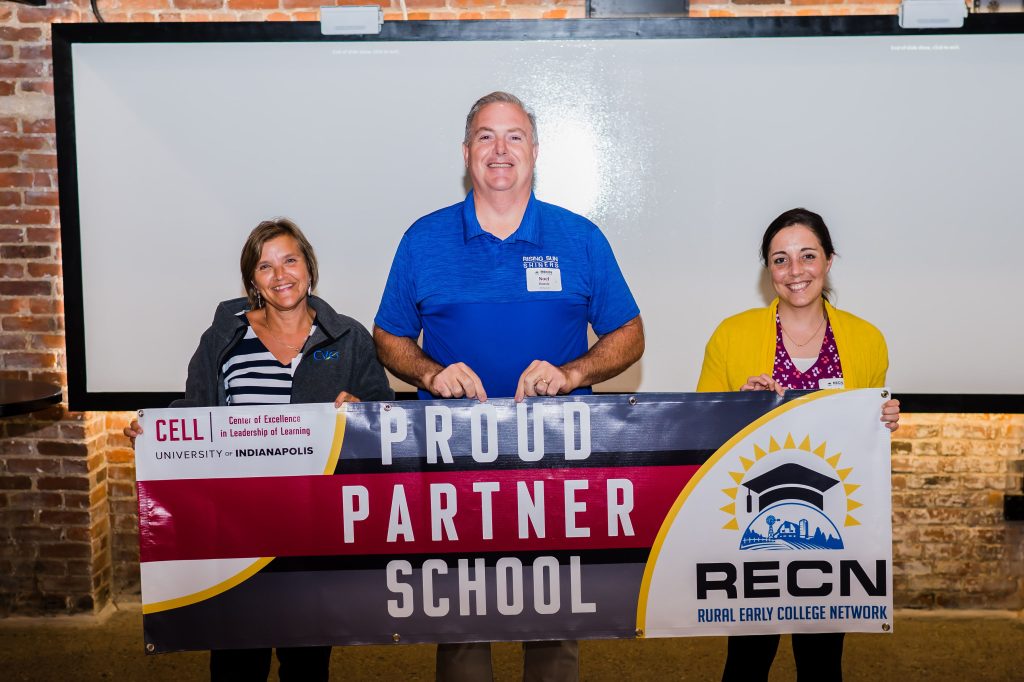 Educators from Rising Sun High School hold a banner during a retreat as part of RECN 1.0