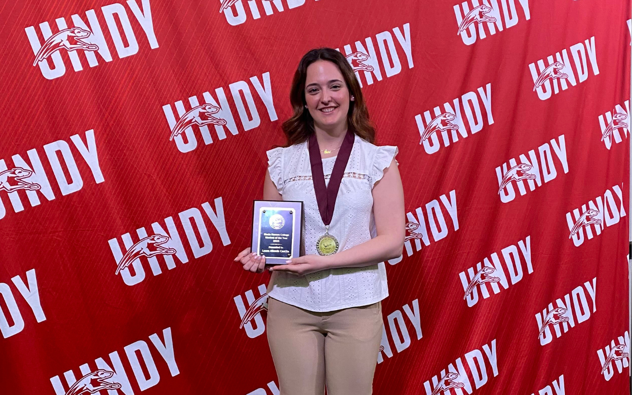 Photo of Laura Allende Castilla holding her Honors Student of the Year plaque