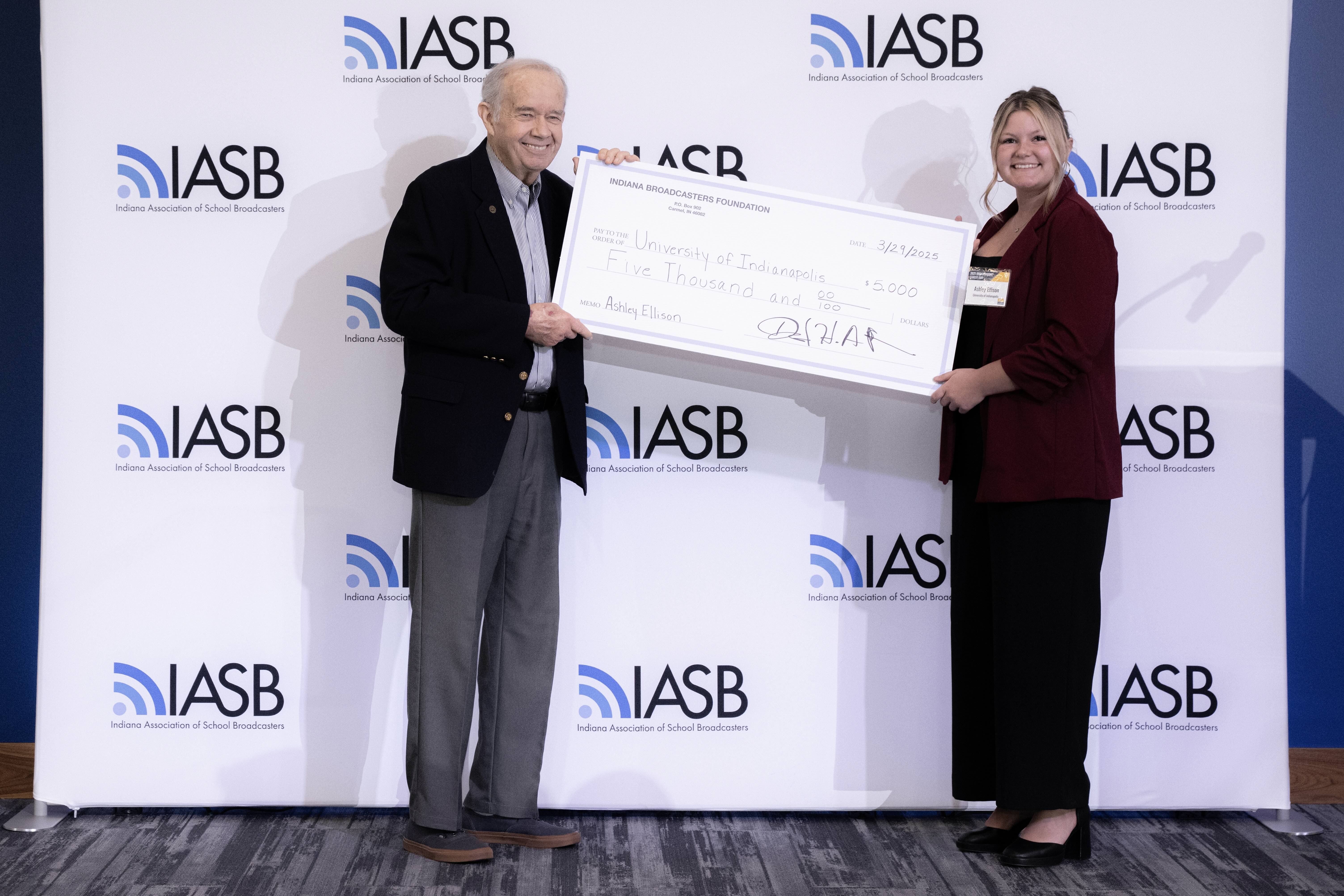 Photo of Ashley Ellison and IBA representative with Ellison's scholarship check