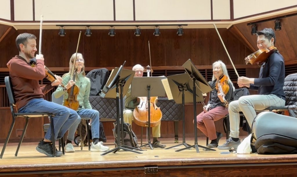 Photo of string quintet rehearsing Vaughn Williams's Phantasy Quintet