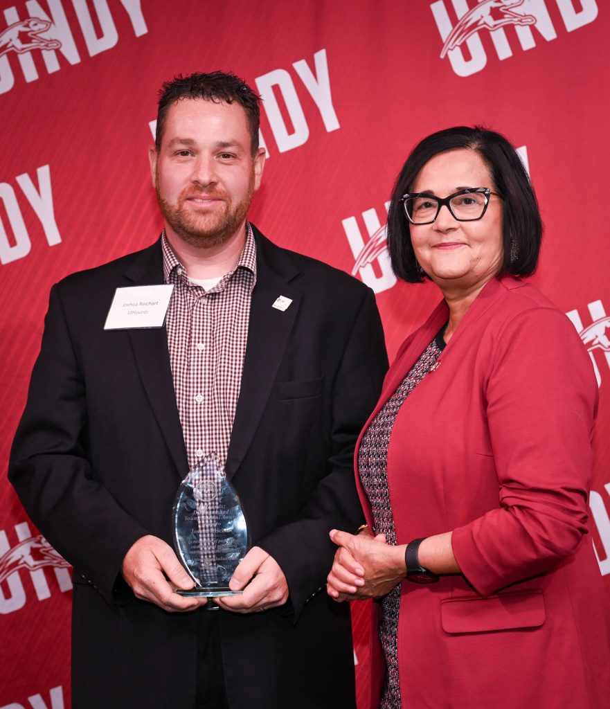 Photo of Joshua Reichart and UIndy President Tanuja Singh