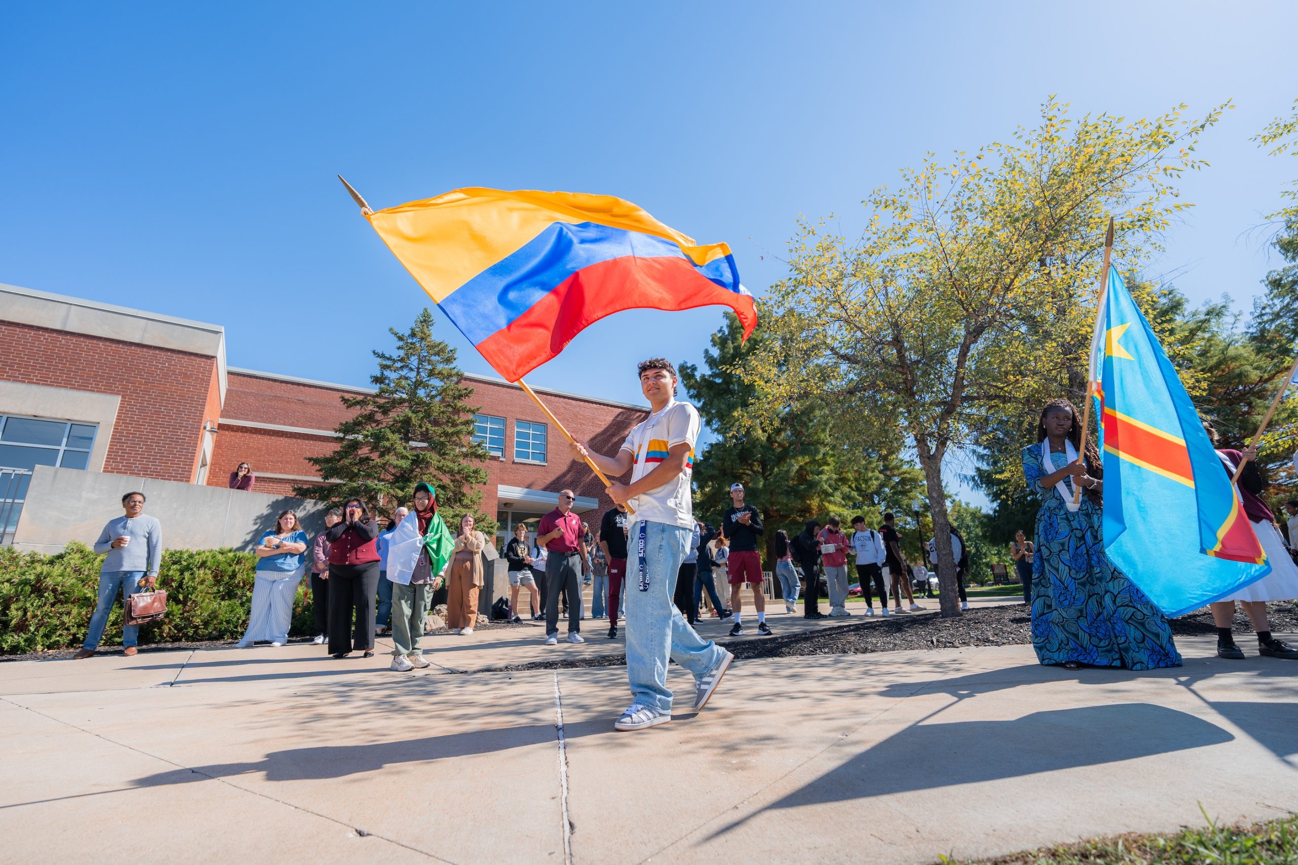 A student holds a flag during the Celebration of Flags 2025