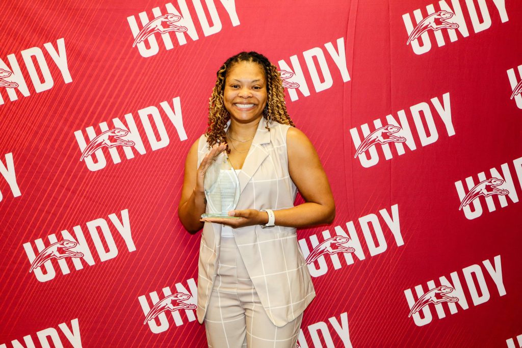 Photo of Portia Benbow holding her 2025 UIndy Alumni Award