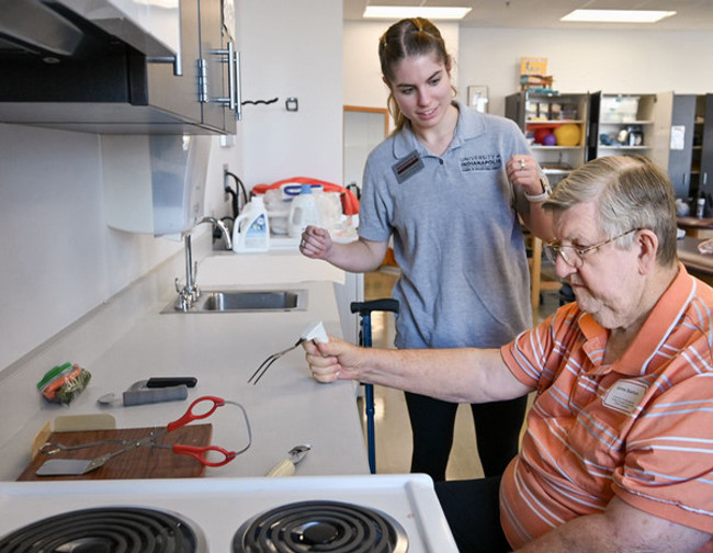 A UIndy physical therapy student works with a Community Patient Resource Group volunteer