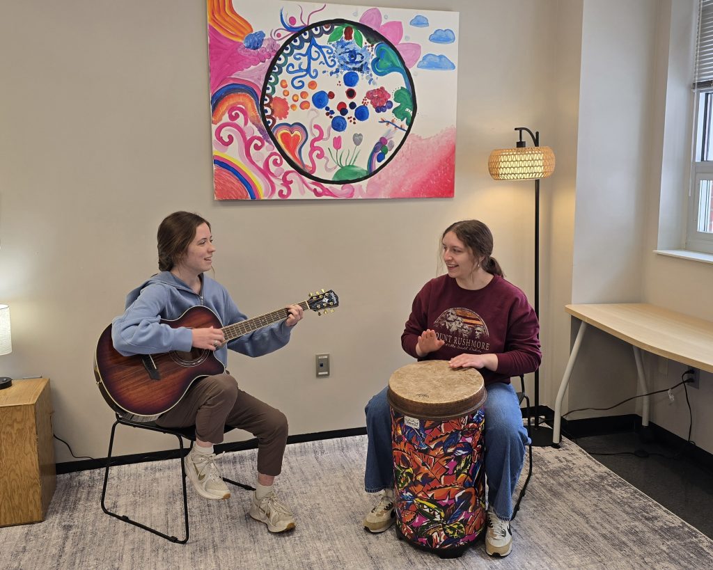 Two people play instruments in the Music Therapy Center