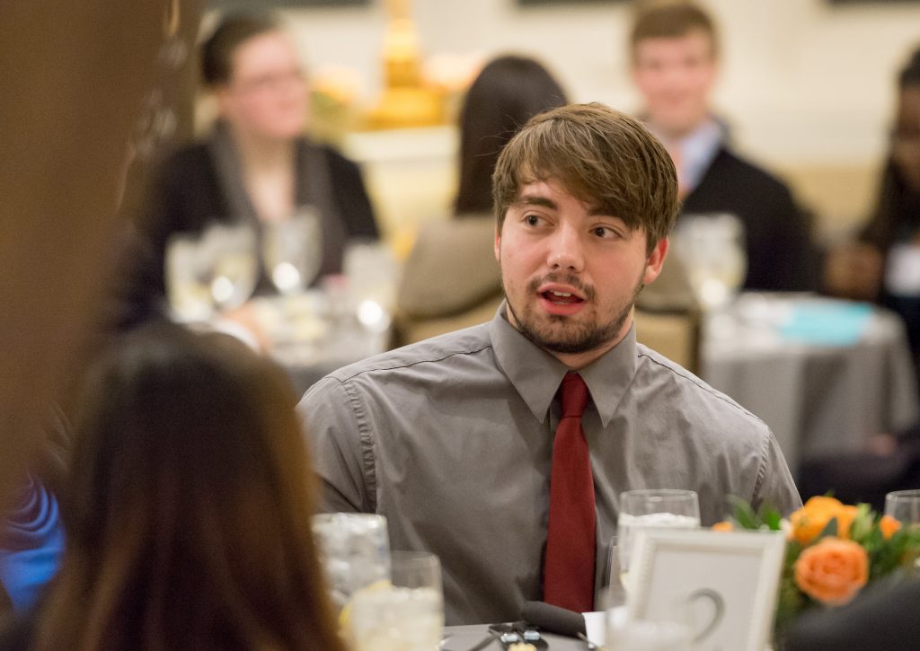 Professionally dressed professionally sit at fancy dinner table