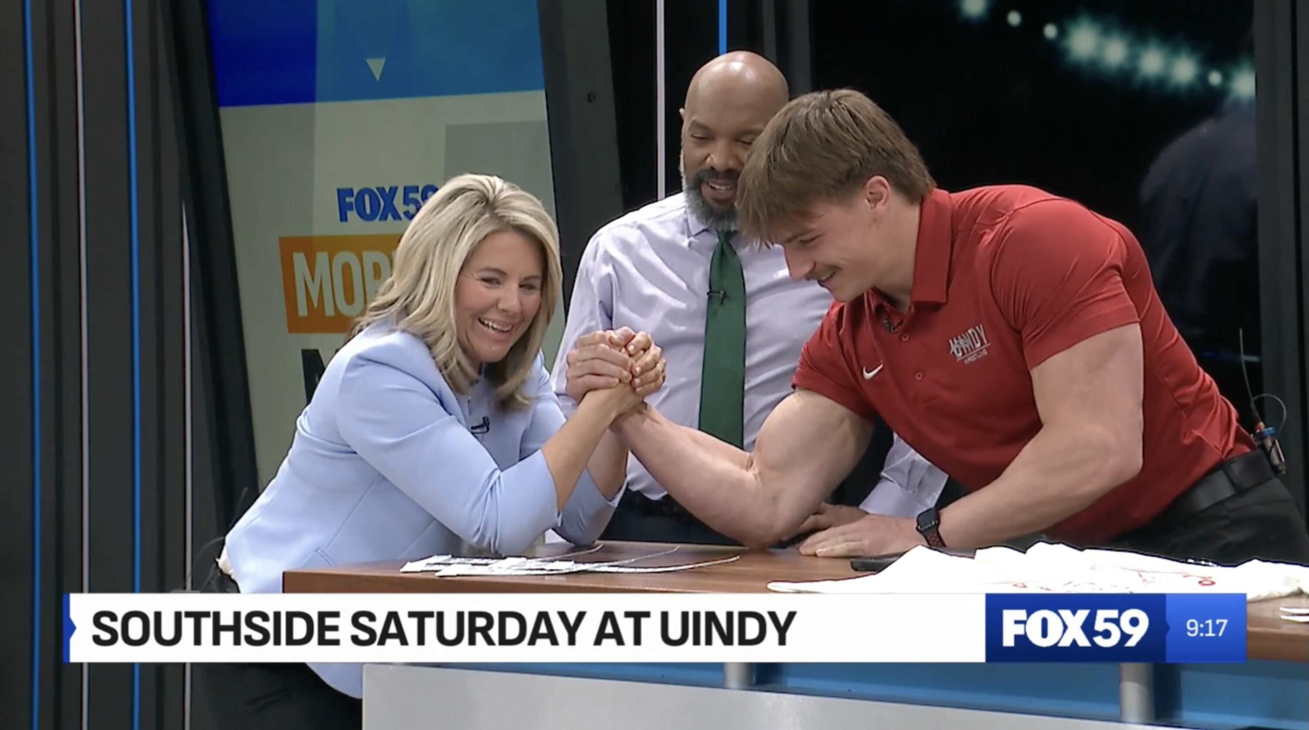 UIndy wrestler and Fox59 anchor arm wrestle to promote Southside Saturday