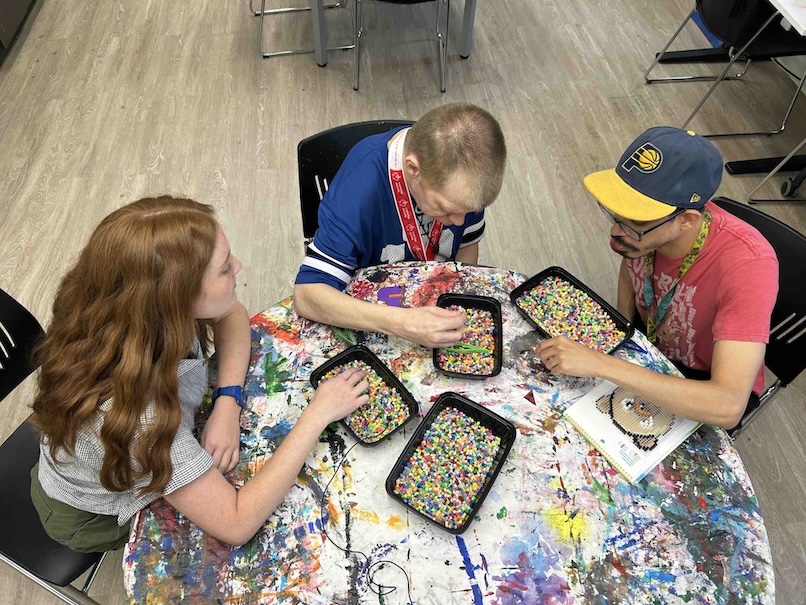 Emily Van Veld ’26 (Mental Health Counseling, Art Therapy) at Noble Art with two clients