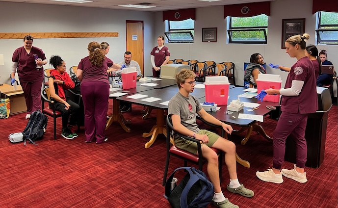 Nursing students give shots at vaccination Clinic at the University of Indianapolis